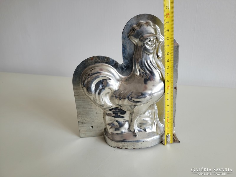 Old metal baking mold in the shape of a rooster, chocolate pouring mold, chicken poultry, Easter confectionery