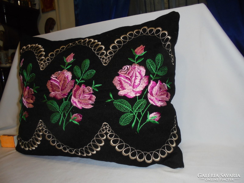 Old, hand-embroidered decorative pillow - pink on a black background