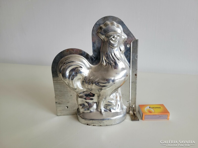 Old metal baking mold in the shape of a rooster, chocolate pouring mold, chicken poultry, Easter confectionery