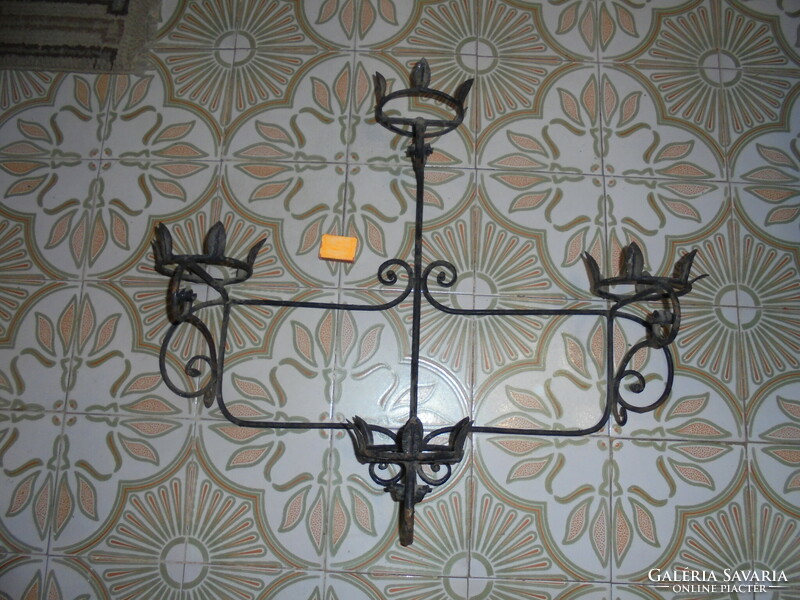 Old wrought iron wall planter for four pots of flowers