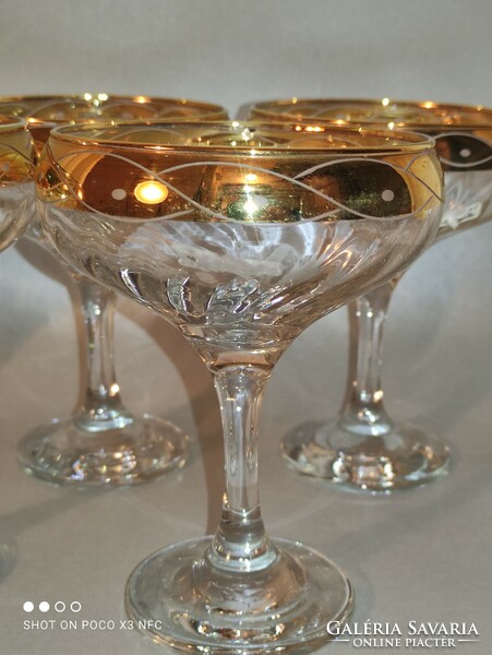 Worth the price!!! Set of 5 champagne glasses with gilded rim marked crystal mode