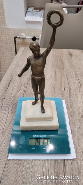 Bronze figural statue on a marble base.