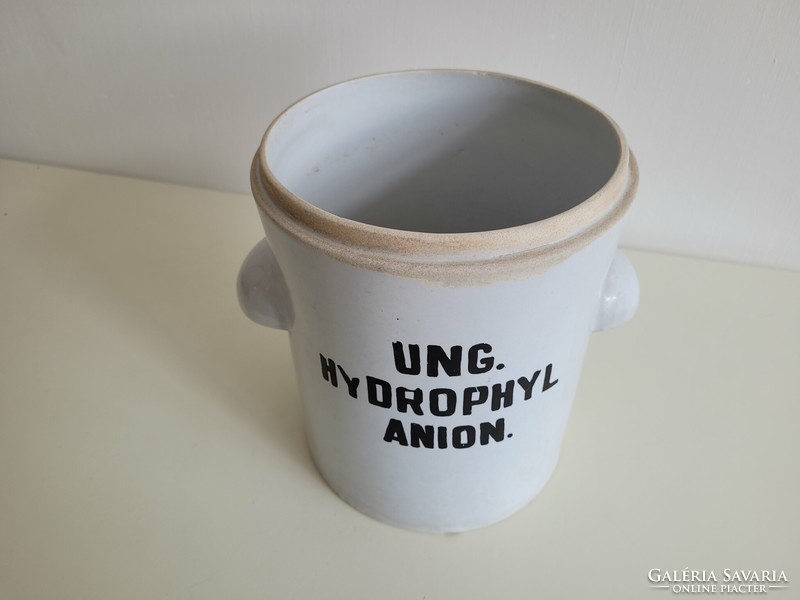 Old large-sized stoneware apothecary jar with a label, a pharmacy storage jar with a handle