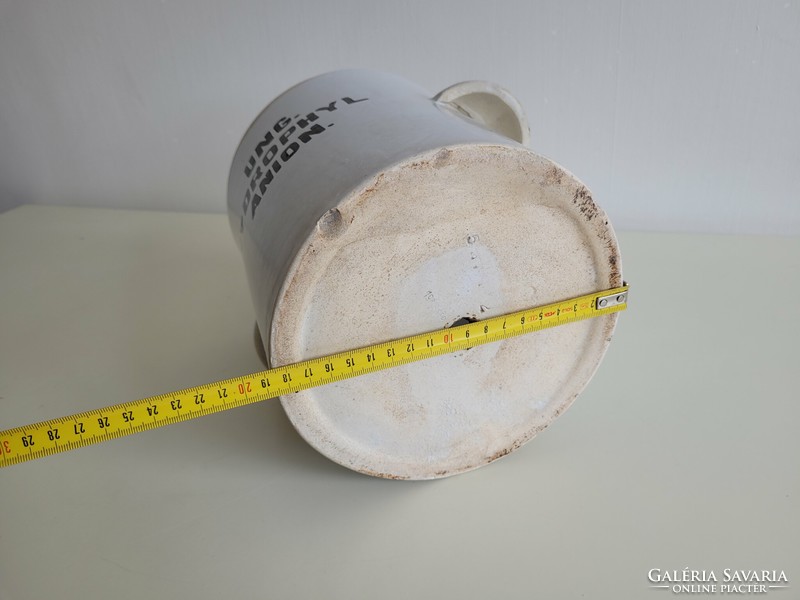 Old large-sized stoneware apothecary jar with a label, a pharmacy storage jar with a handle