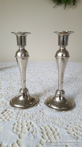 A pair of graceful, silver-colored candle holders