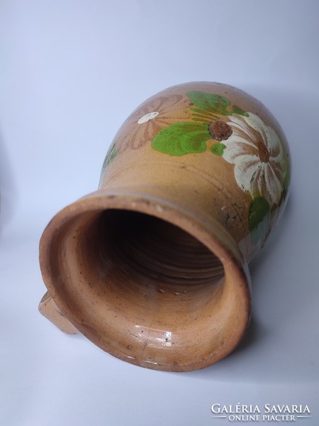 Old painted folk earthen pot with flowers