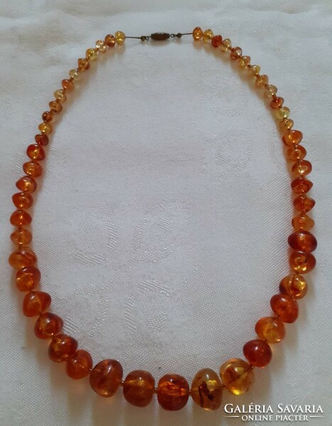 Older imitation amber necklace with growing eyes