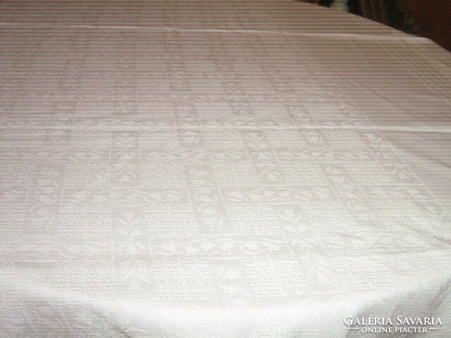 A beautiful white woven damask tablecloth with a tulip pattern