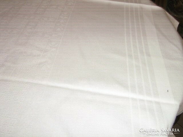 A beautiful white woven damask tablecloth with a tulip pattern