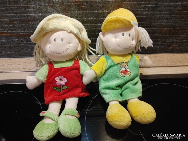 Two smiling doll toy figures in a pair