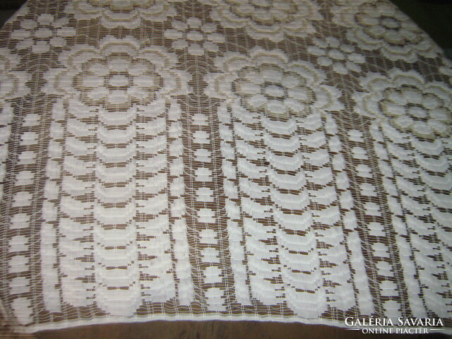 A white and cream curtain richly embroidered in a fabulous vintage-style material