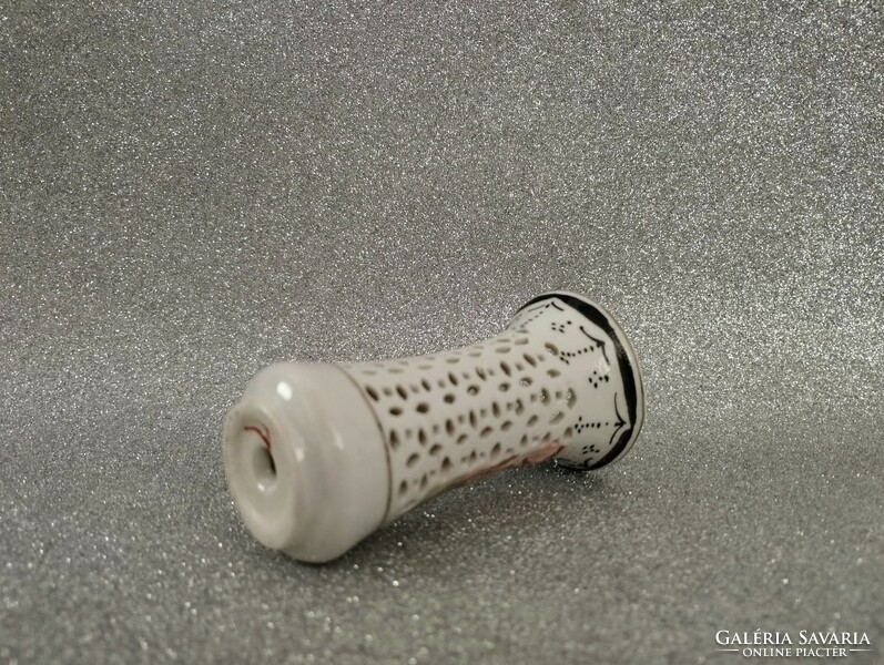 Porcelain candle holder with a pierced pattern
