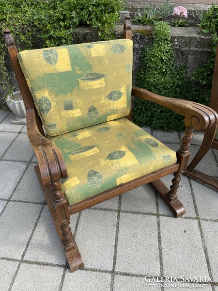 A pair of comfortable old armchairs with canvas covers