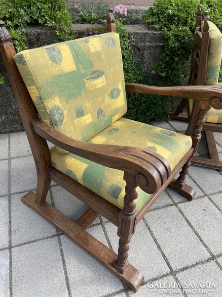 A pair of comfortable old armchairs with canvas covers