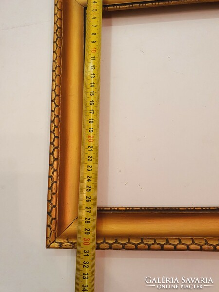 Wooden picture frame with an elegant pattern. Old.