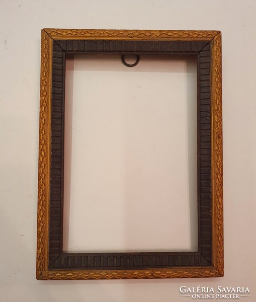 Wooden picture frame with carved pattern. Old.