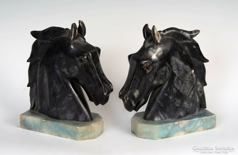 A pair of art deco style marble bookends in the shape of a horse's head