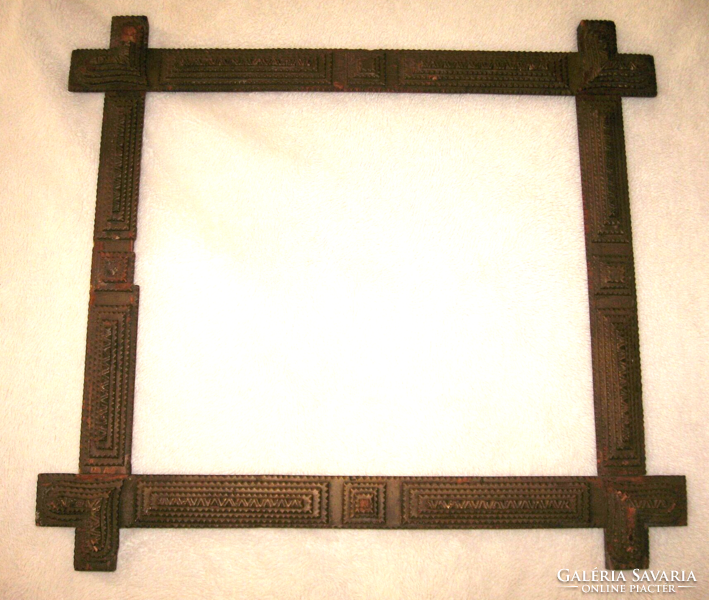 Old tramp art frame with a heart motif on the corner