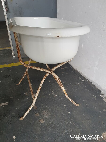 Old enameled tub with holder
