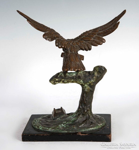 Bronze statue of an eagle with a telephone in its beak