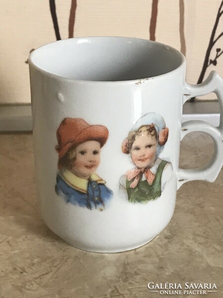 A very old cup with a special double handle