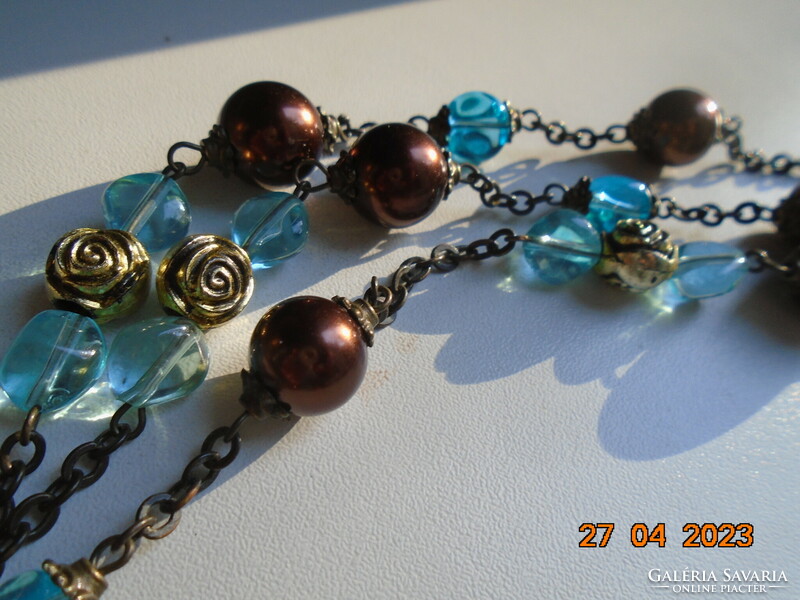 Long 2-row necklaces of antique gold, rose-shaped gold and turquoise beads strung on a bronze-colored chain