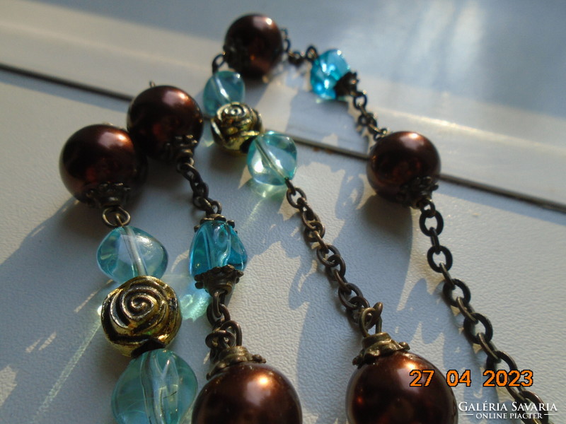 Long 2-row necklaces of antique gold, rose-shaped gold and turquoise beads strung on a bronze-colored chain