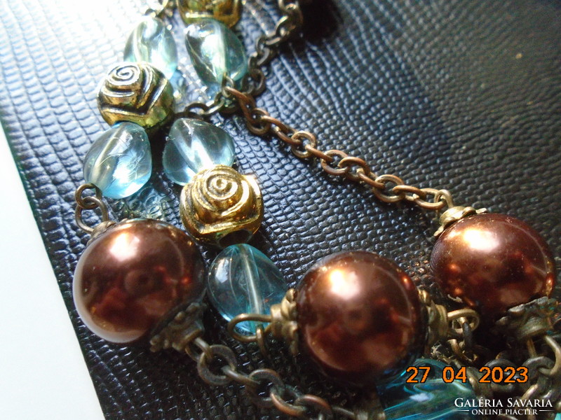 Long 2-row necklaces of antique gold, rose-shaped gold and turquoise beads strung on a bronze-colored chain