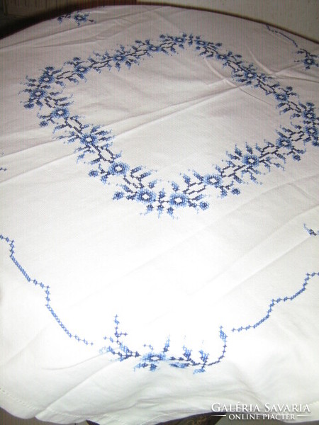 Beautiful hand-embroidered white tablecloth with a blue motif