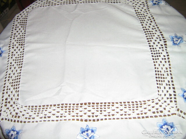 Beautiful hand-crocheted edge and crocheted inset machine-embroidered blue floral tablecloth