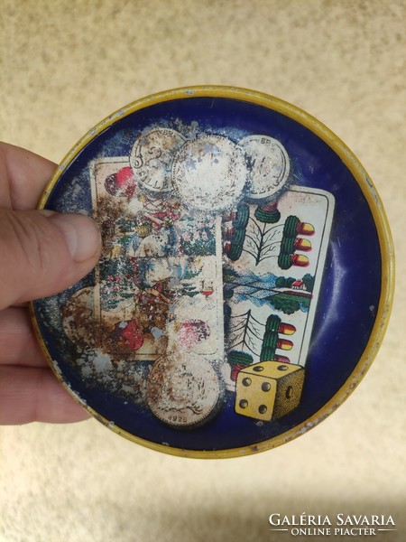 Enamel bowl holding old tokens and coins