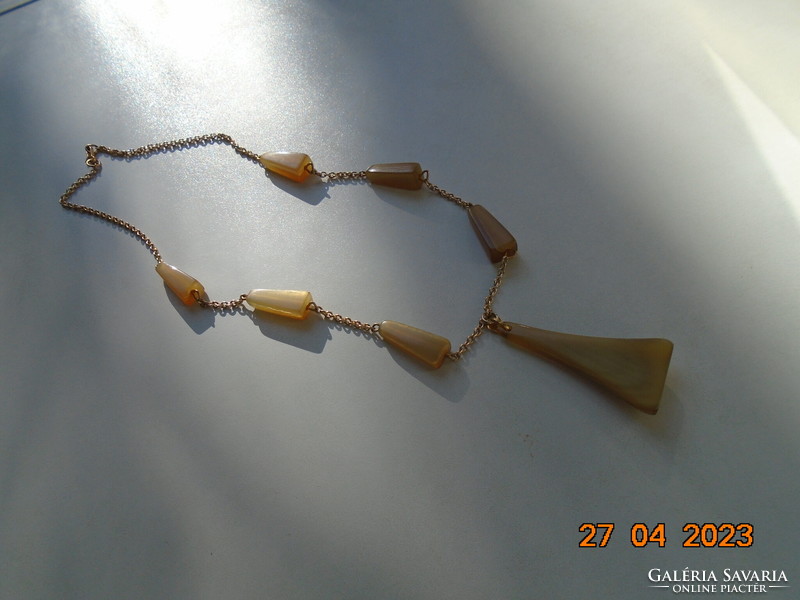 Art deco carved horn made of geometrically shaped beads with a blue gilded chain