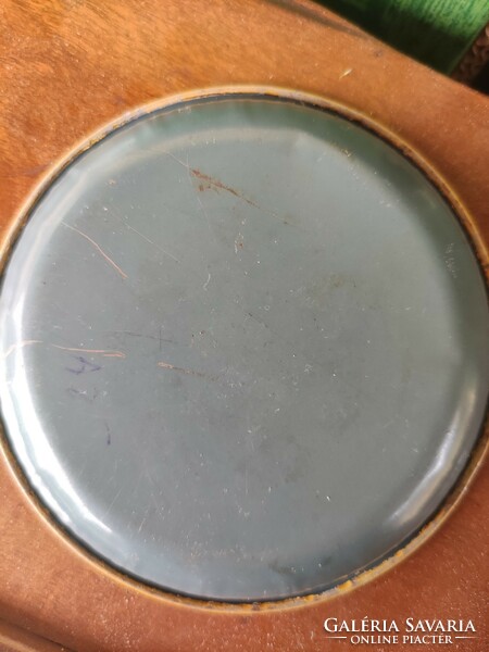 Enamel bowl holding old tokens and coins