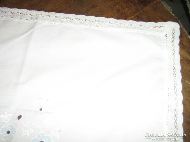 Beautiful and elegant light blue madeira tablecloth with floral embroidery and lace edge