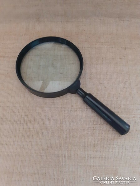 A well-maintained large handle magnifier with a unscrewable handle
