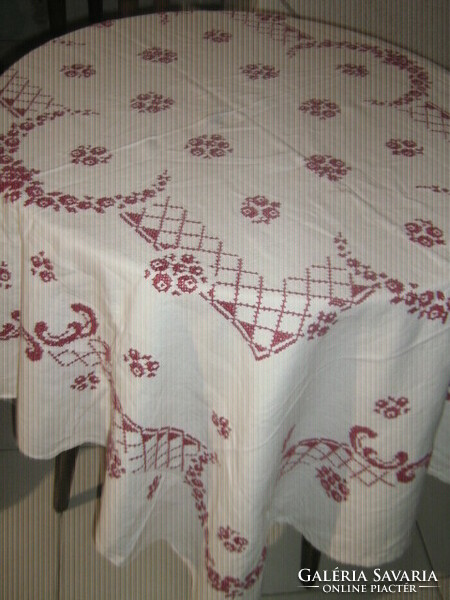A dreamy tablecloth richly embroidered with antique cross stitch