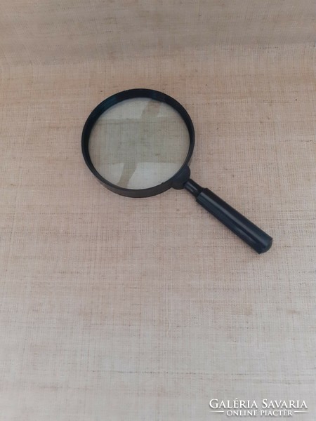 A well-maintained large handle magnifier with a unscrewable handle