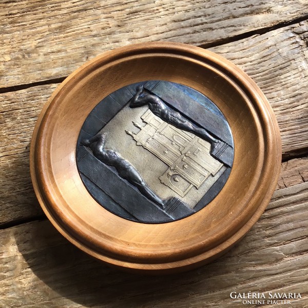 Old art deco bronze plaque in a wooden frame