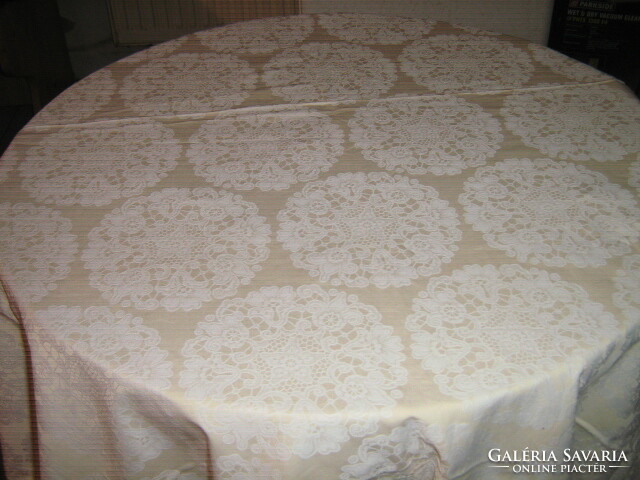 Beautiful damask tablecloth with white flowers on a yellow background