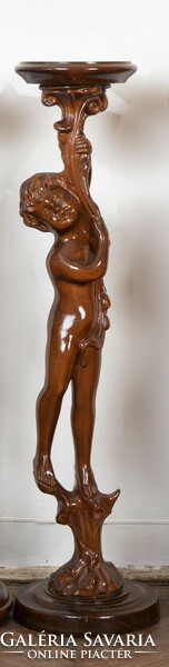 Carved wooden pedestal with a child figure