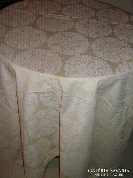 Beautiful damask tablecloth with white flowers on a yellow background