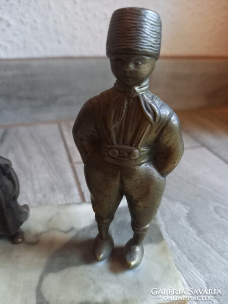 Old bronze statues (father, mother, their little girl) on a marble plinth