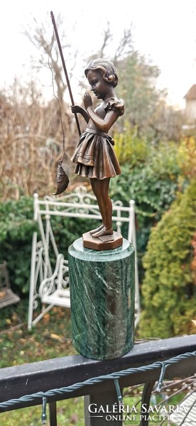 The girl caught a fish - bronze statue