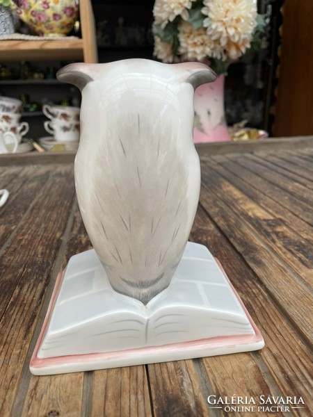 Porcelain owl sitting on a large book