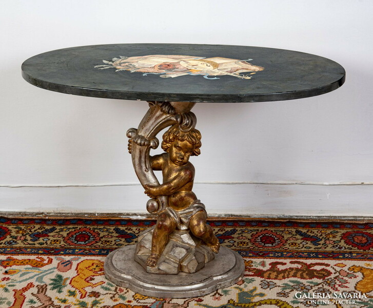Baroque coffee table with a painted ceramic plate on top