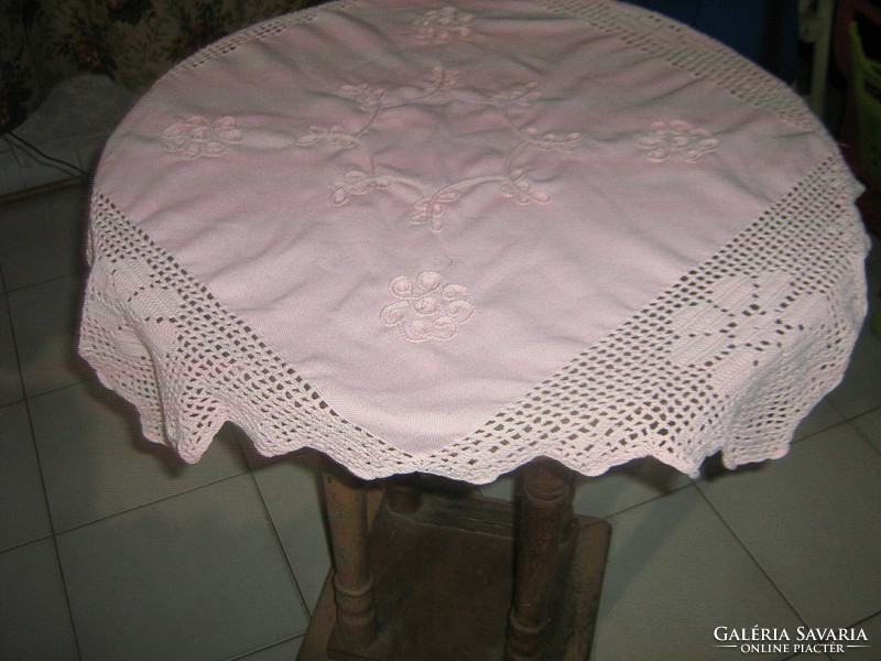 Cute hand-crocheted pink tablecloth with a sewn-on floral border