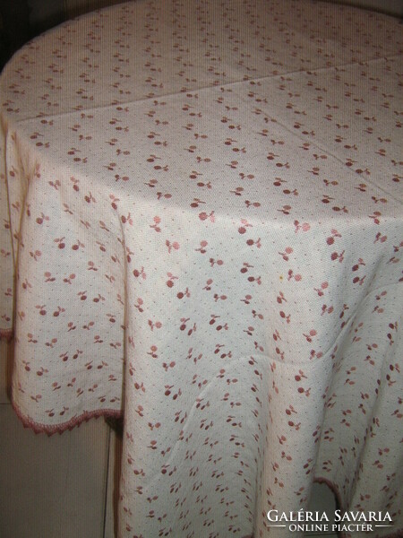 A beautiful and elegant cherry colored tablecloth with a lace edge