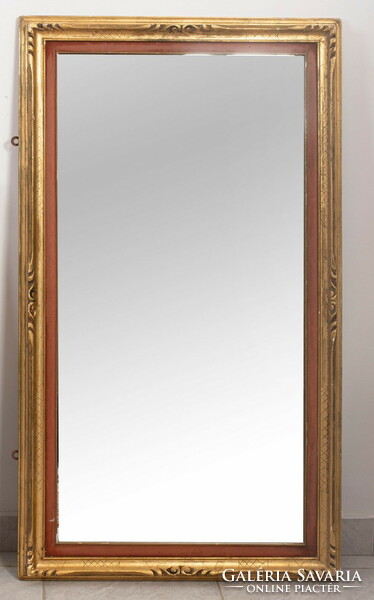 Gold-plated mirror with a frame painted red on the inner edges