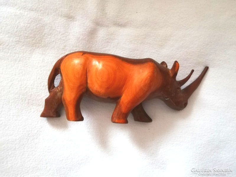 A wooden ornament with a rhino horn carved from wood