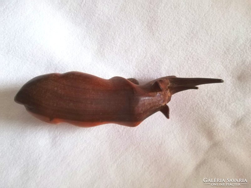 A wooden ornament with a rhino horn carved from wood